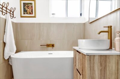 Port Noarlunga South bathroom renovation, brass tapware detail Freestanding bath and timber vanity with brass tapware in a renovated bathroom