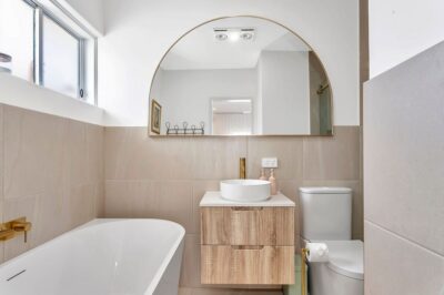 Port Noarlunga South bathroom renovation, freestanding bath Second renovated bathroom with a freestanding bath, arch mirror and timber vanity