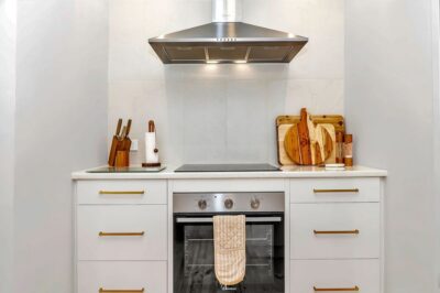 Port Noarlunga South kitchen renovation, cooktop and rangehood New cooktop, oven and rangehood with stone benchtop in a renovated Adelaide kitchen