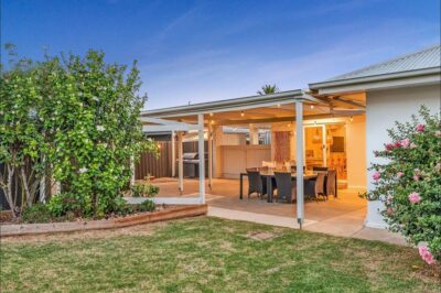 Port Noarlunga South pergola and outdoor living area Resheeted and repainted pergola lit at dusk off the rear of a Port Noarlunga South home